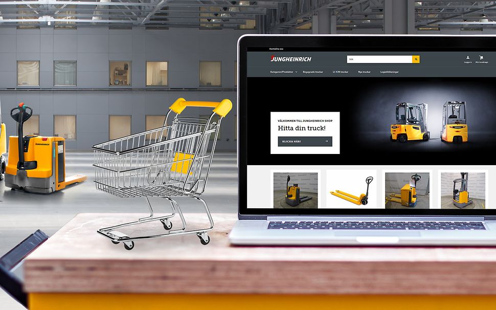 Laptop med Jungheinrich shop med gula nya och begagnade Jungheinrich truckar i bakgrunden.