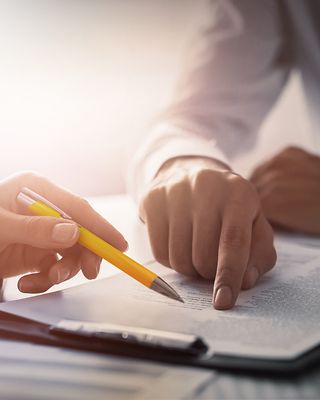Human hands working with documents at desk_[MAM-49820]