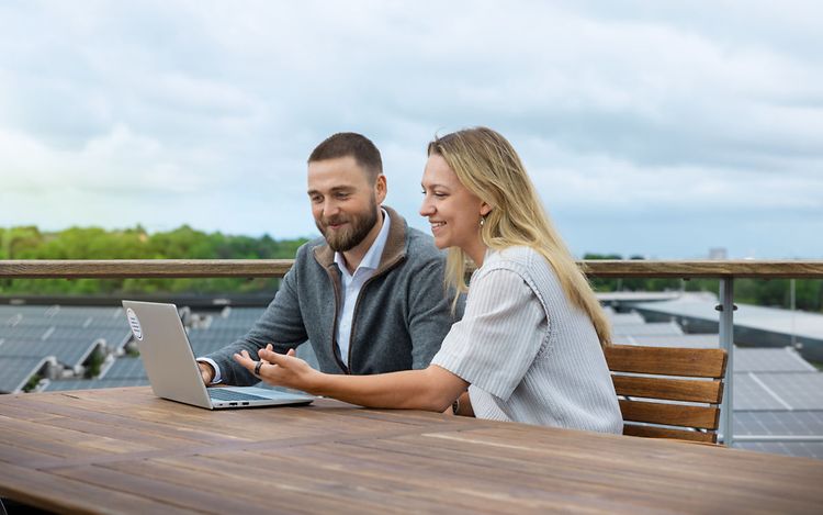 Two people looking at a laptop