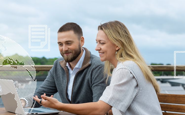 Two people looking at a laptop