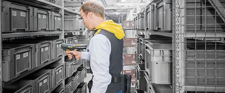 Man står på lageret med en stregkodescanner fra Jungheinrich.