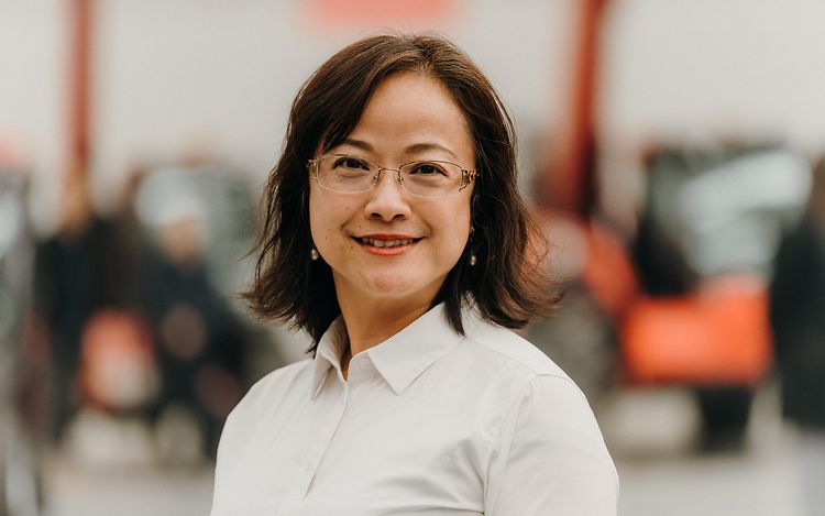 Adele Zhang looks straight into the camera and smiles.