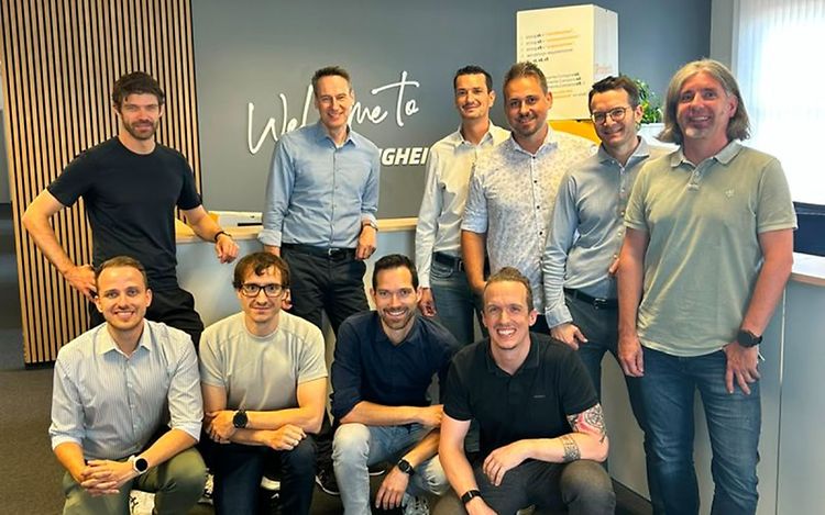 A group of ten men are smiling directly at the camera.