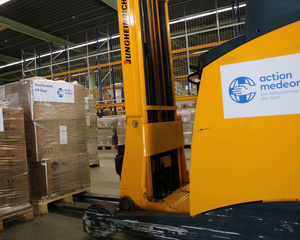 A yellow forklift truck is lifting a pallet of crates.